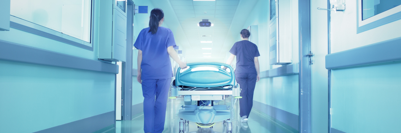 What Shoulder Surgery Taught Me About Life Two nurses wheeling a hospital bed down a hallway.