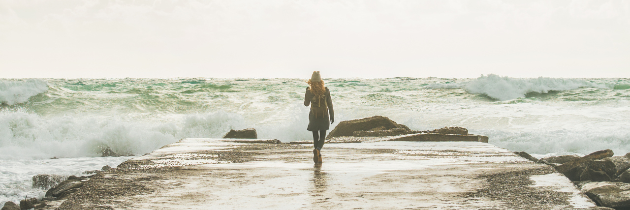 How to Manage Life While Living With Sjogren's Syndrome Young woman tourist standing on pier and enjoying waves of stormy Mediterranean sea in winter, Alanya, Turlkey, square crop