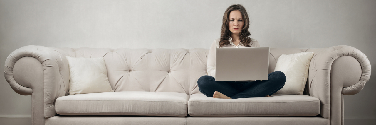 What I Learned While Volunteering for RAINN's Crisis Hotline woman working on computer on couch
