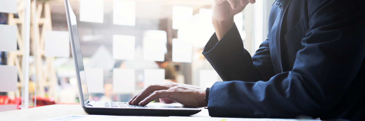 'Ask a Manager' Letter: Employee Took Photos of Co-Worker's Stoma Bag businessman working analysis business information at office with laptop and documents on his desk.