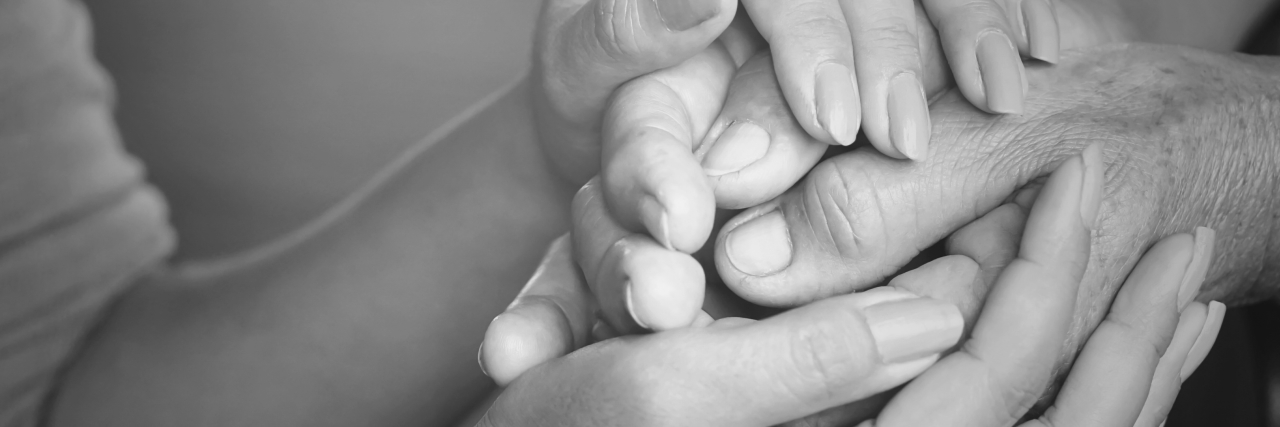 a daughter holding her father's hand on Father's Day