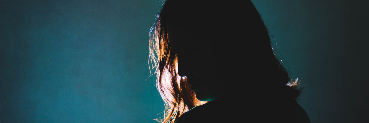 Why Our Doctors Need to Practice 'Pain Acceptance silhouette of sad woman standing in the dark with light shine behind