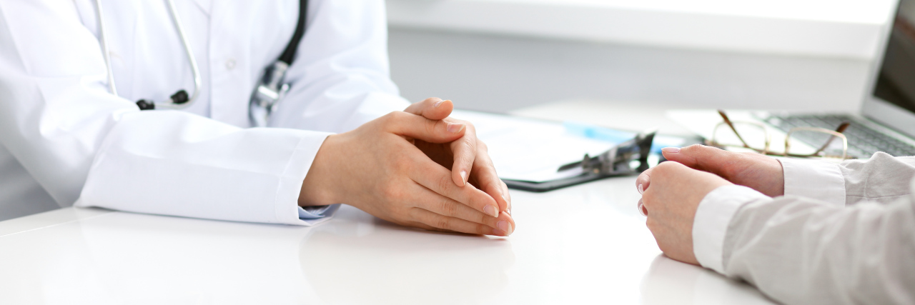 When Doctors Are Insensitive to Mental Illness Doctor and patient sitting at the desk. Medicine and health care concept