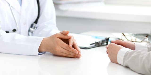 When Doctors Are Insensitive to Mental Illness Doctor and patient sitting at the desk. Medicine and health care concept