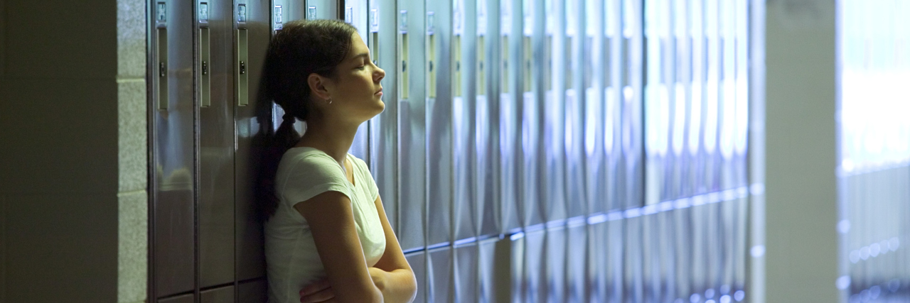 When Schools Don't Take the Time to Understand Your Mental Illness Teenage girl standing by lockers