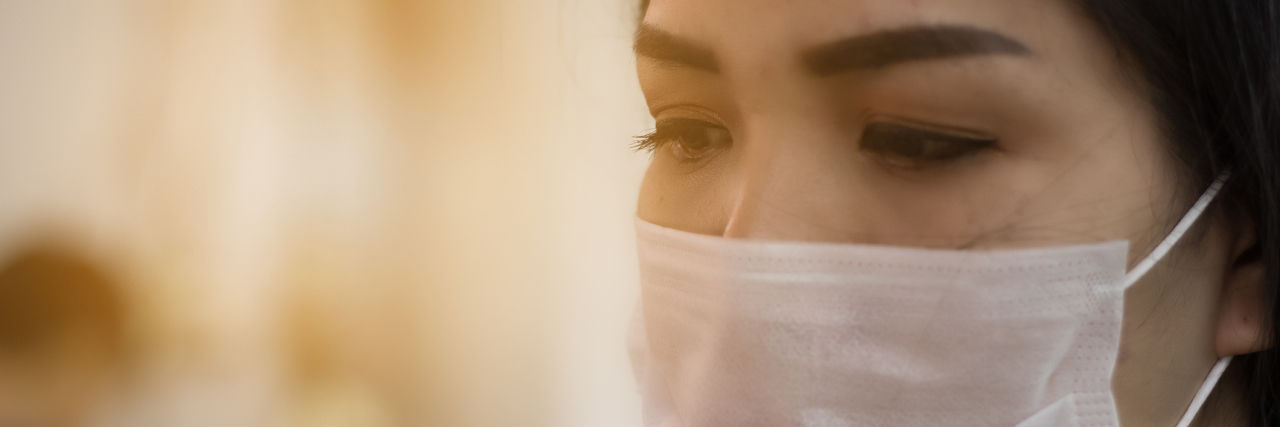 woman wearing mask to protect from being sick