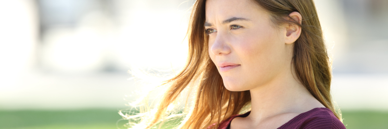 woman sitting on a bench and thinking