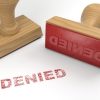 Two rubber stamps with the word denied and a stamp on white background.