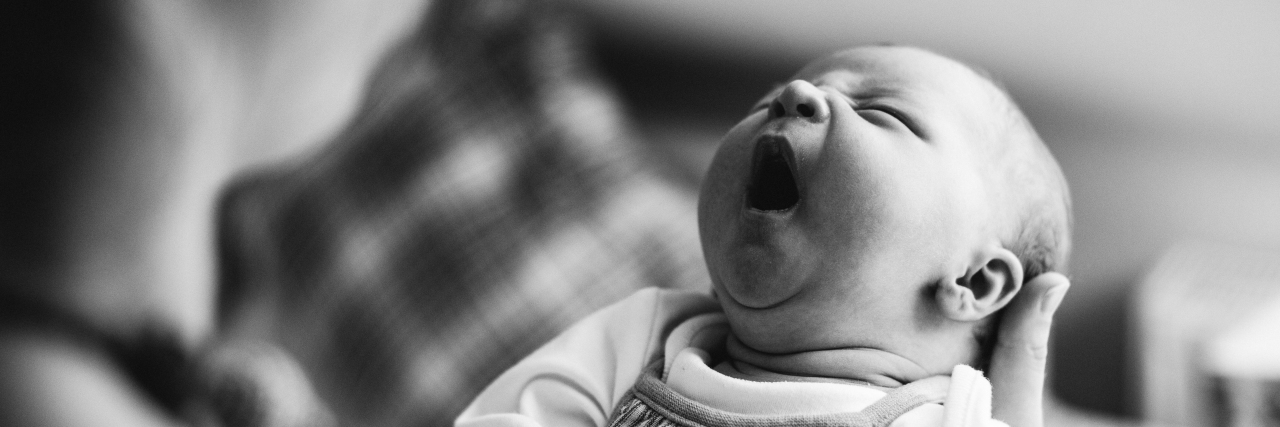 Parenting a Child With WAGR Syndrome Unrecognizable young mother at home holding her crying newborn baby girl.