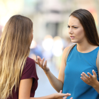 Two women talking seriously on the street.