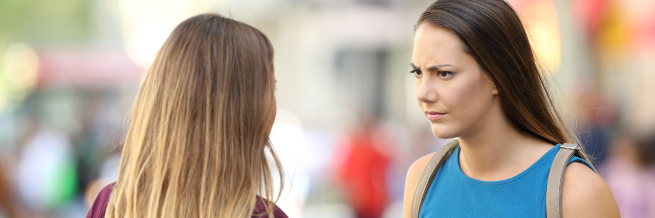 How to React When People Say Insensitive Things About Mental Illness Two angry friends having a serious conversation outdoors on the street