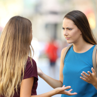 Two angry friends having a serious conversation outdoors on the street