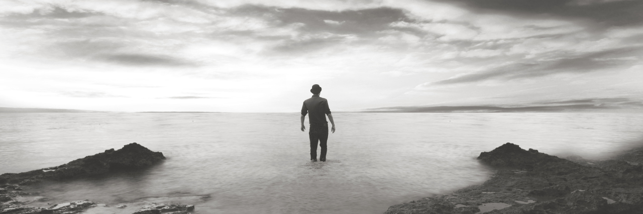 Why You Shouldn’t Say ‘You Can Do It’ to a Person With Depression silhouette of man walking in water with stormy sky