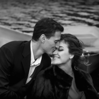 black and white photo of a couple kissing on a boat