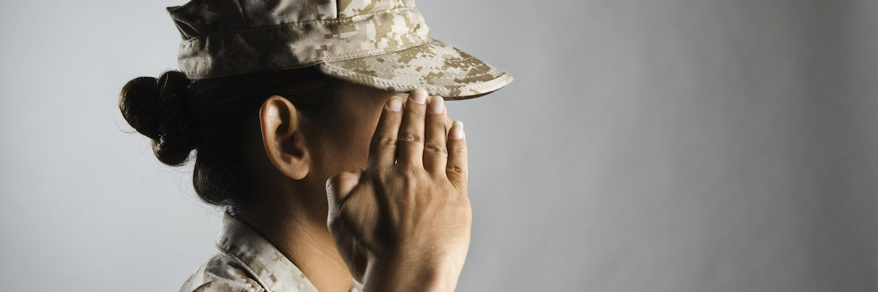 A Female Veteran With PTSD Hopes to Connect With People Who Understand A woman in uniform saluting