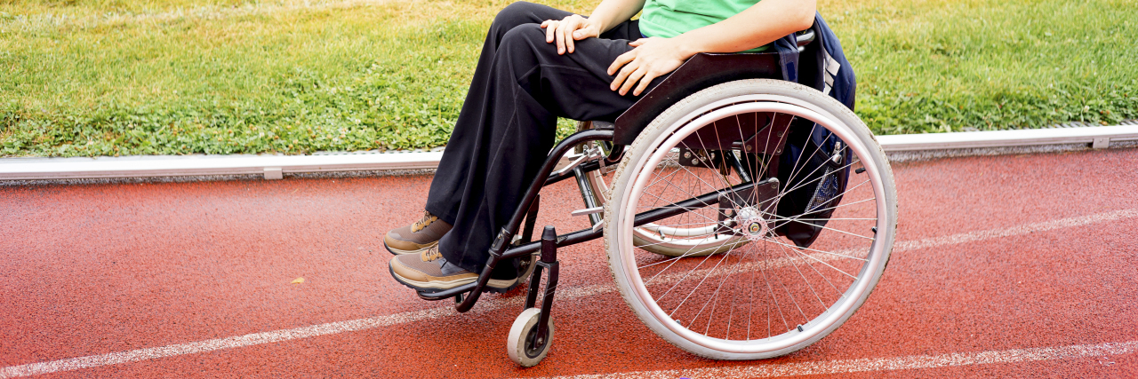 Woman in a wheelchair on racetrack.