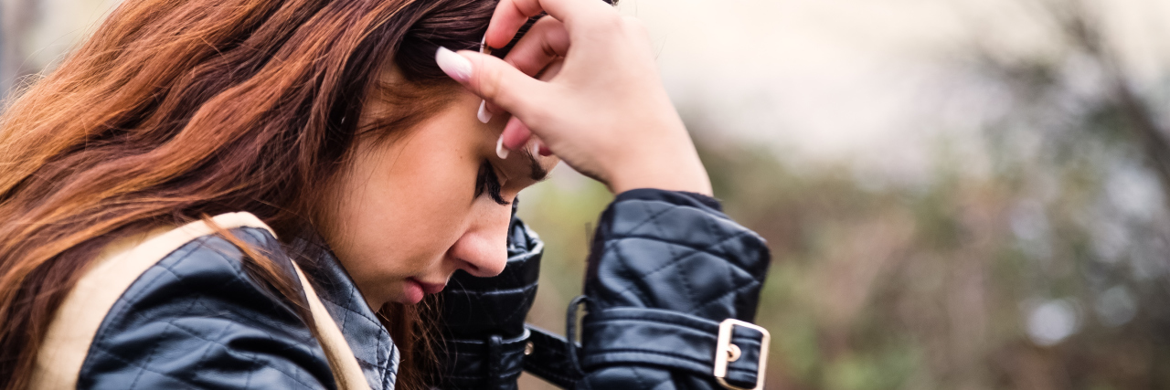 Being an Introvert With Avoidant Personality Disorder woman standing on bridge looking down feeling lonely