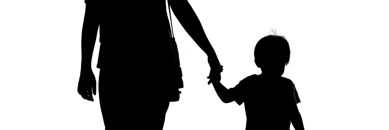 Silhouette of a mother holding her son isolated on white background