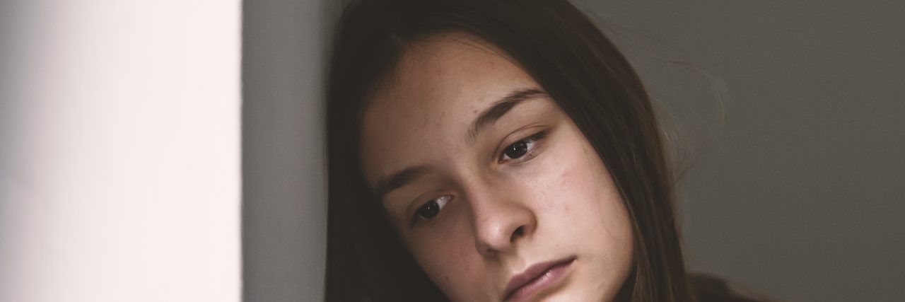 What I Wish My Loved Ones Understood About My Grief Depressed teenager sitting lonely