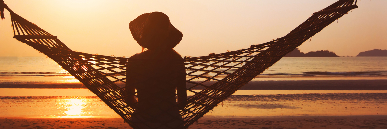 New Year's Resolutions for People With Chronic Pain Woman in hammock enjoying sunrise.