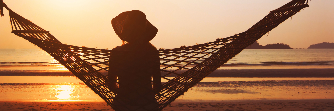 Woman in hammock enjoying sunrise.