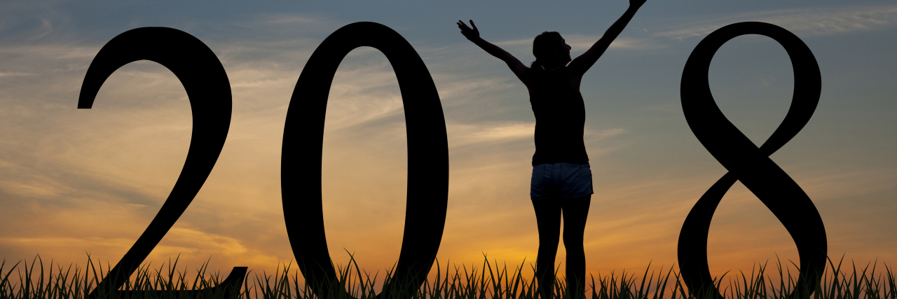 Starting a New Year as a TBI Survivor Person silhouette standing in 2018 on the hill at sunrise.