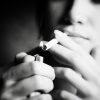 Smoking woman. Focus on cigarette lighter.