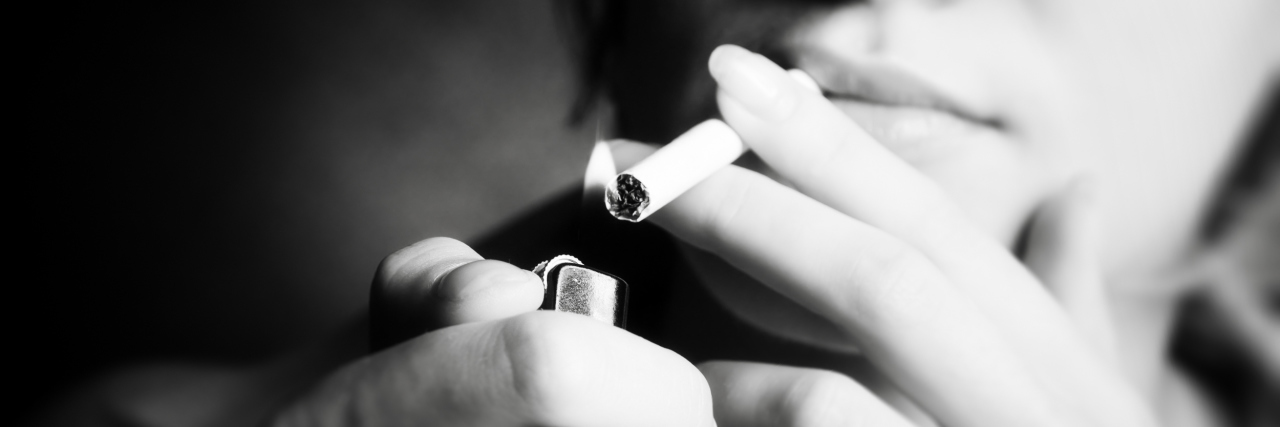 When Asked the Question 'Did You Smoke?' Smoking woman. Focus on cigarette lighter.