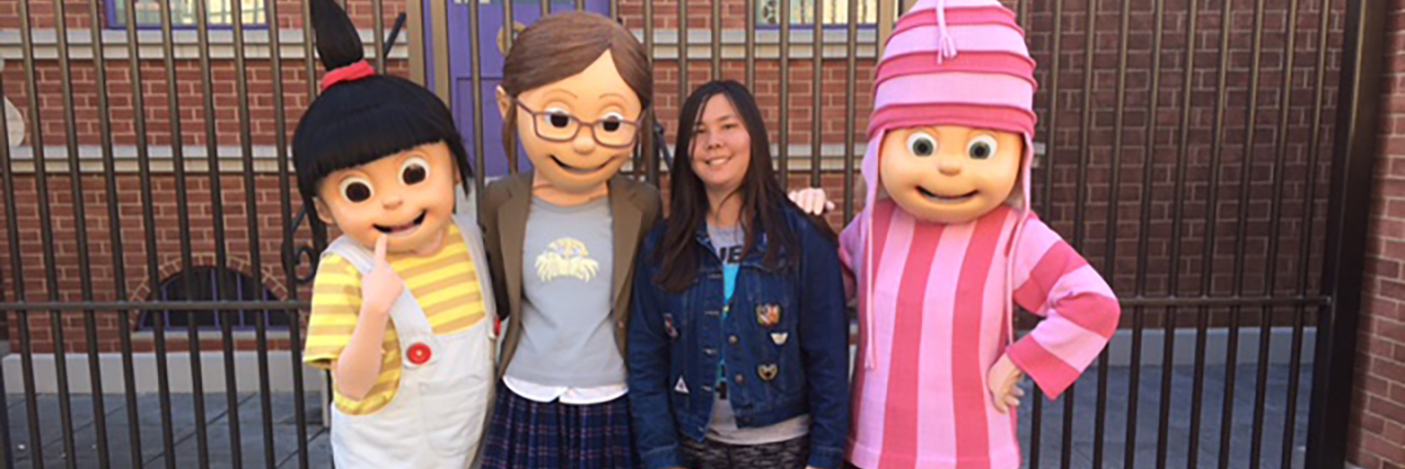Pressure to Be 'Age Appropriate' Can Harm Autistic People Christine posing wth characters from "Despicable Me."