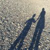 The shadow of the author and her son holding hands