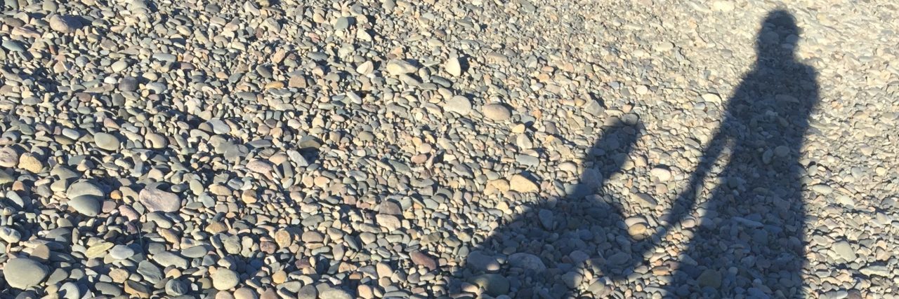 Having Hope When Parenting a Child With Angelman Syndrome The shadow of the author and her son holding hands