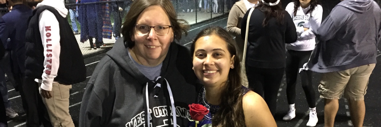 young woman standing with her mother