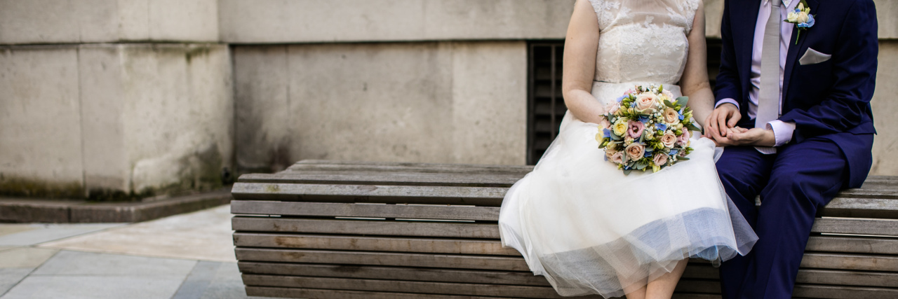 Getting Married When You Have POTS husband and wife sitting on a bench after getting married