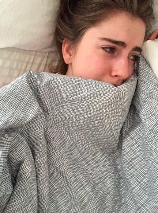 woman crying in bed