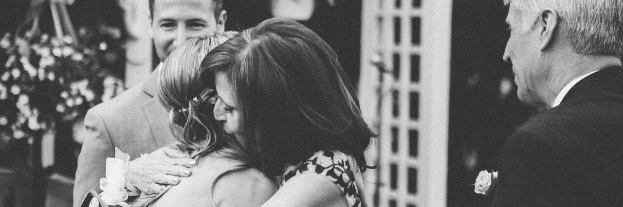 To the Mother Whose Child Is Hurting Black and white image of grown daughter hugging her mother