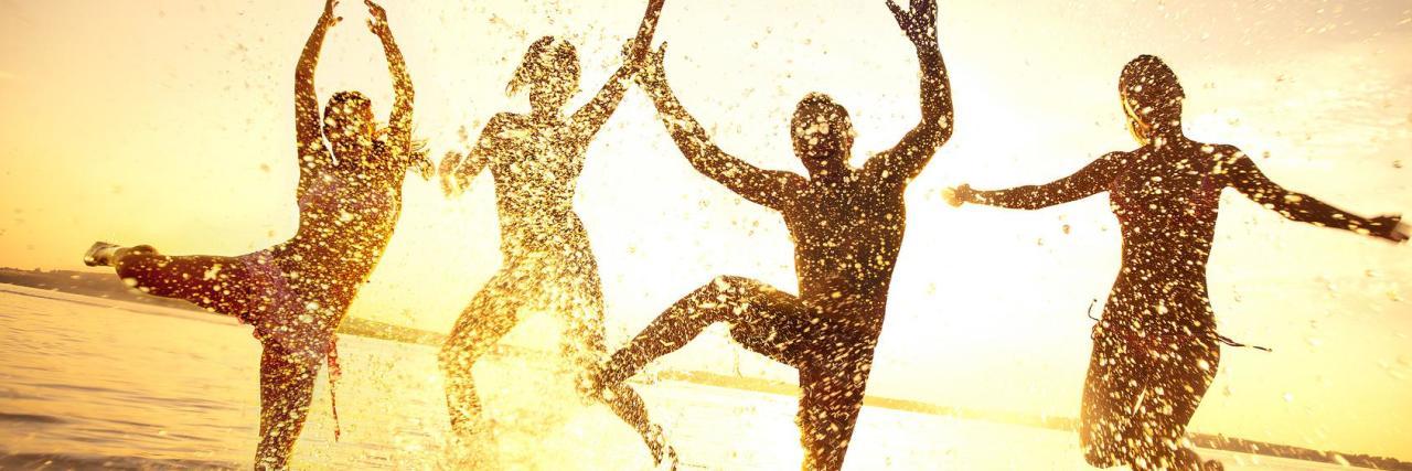 Living With Society's Expectations As a Person With Chronic Illness four people jumping in the water