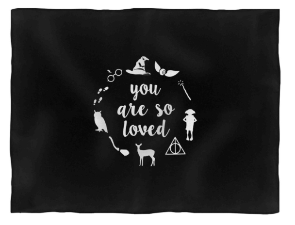 black blanket that says you are so loved with harry potter symbols