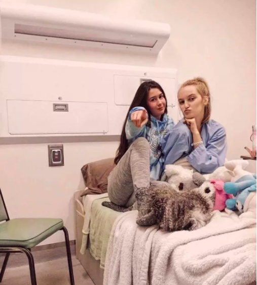 two women sitting in psych ward hospital room