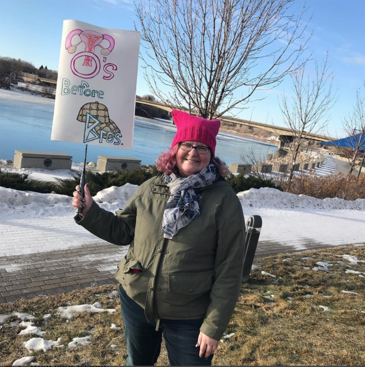 woman holding women's march sign
