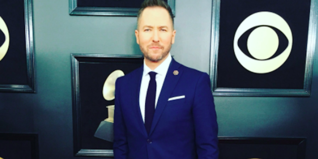 radio host ted stryker wearing a pin for chester bennington at the grammys