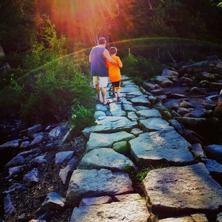 My husband and son making their way across a rocky path.