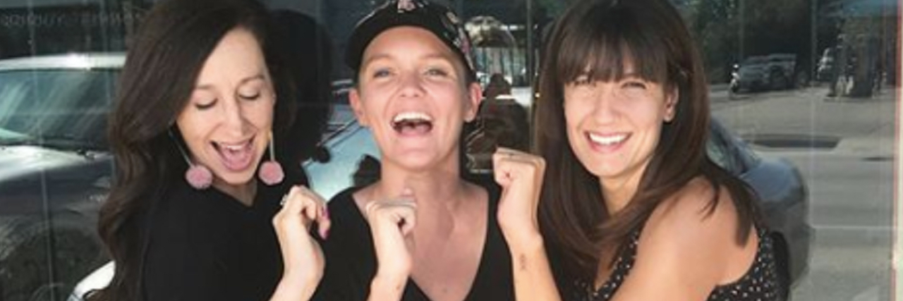 Parents of Kids With Down Syndrome Are Getting This Tattoo Group of women standing outside of a tattoo shop showing off their forearms which have three arrows tattooed.