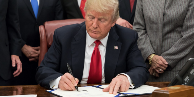 Trump signing a document