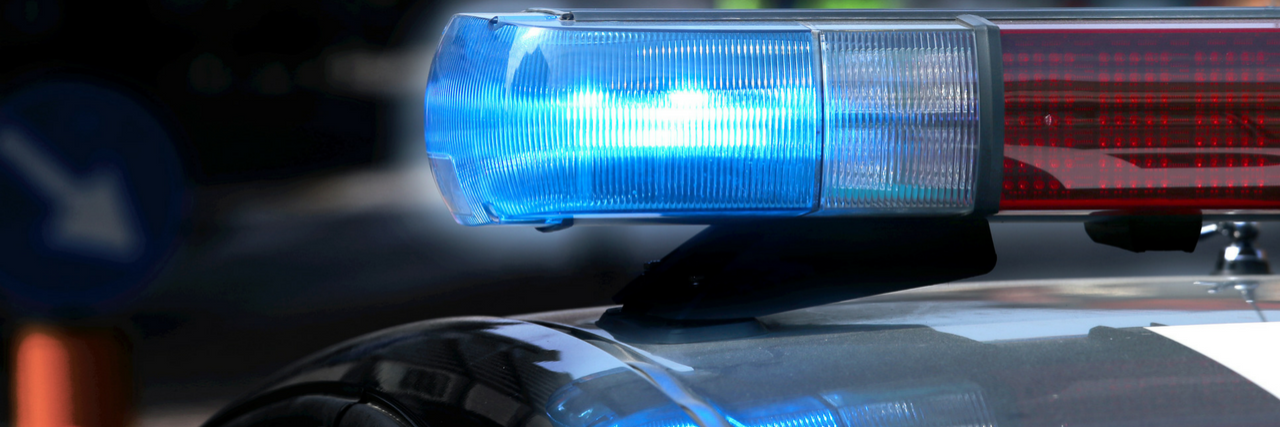 Former Autism Society Board Member Charged With Child Abuse top of police car