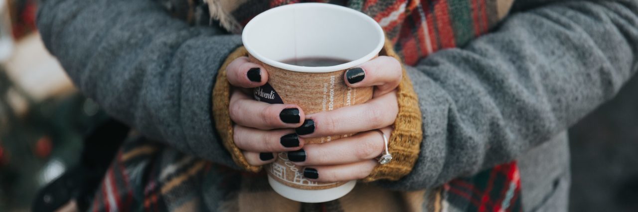 What to Do If You Are an Introvert With a Mental Illness woman wearing scarves and holding coffee cup