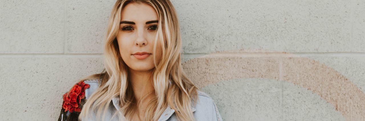 What 1,000 Days With Depression Has Been Like woman with blonde hair and jean jacket looks at the camera