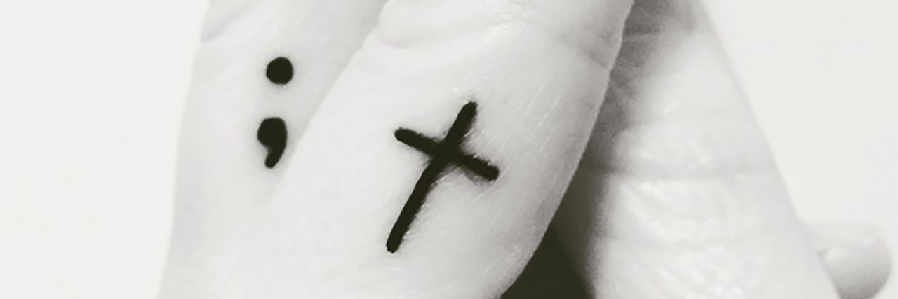 Why I Got a Semicolon and Cross Tattoo After My Suicide Attempt black and white photo of semicolon and cross tattoo on woman's fingers