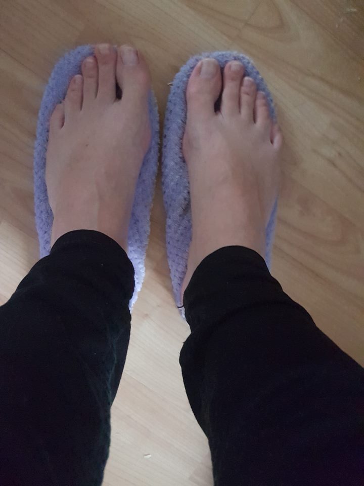 woman standing on purple towels