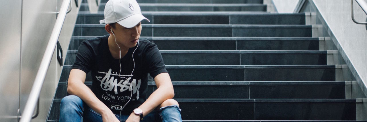 The 'Paradoxes' I Live With as Someone With Depression man sitting on stairs