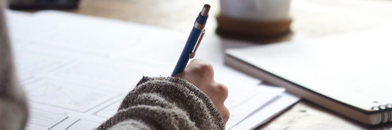 What I Wish My Employer Understood About Sensory Processing Disorder Emily drawing at a table.